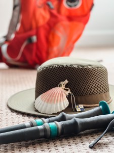 Hat, shell, bag, boots, and hiking poles.